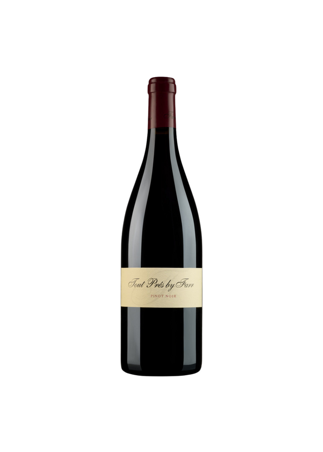 A bottle of Wine By Farr Tout Pres Pinot Noir 2022 with a dark label and red wine visible inside the bottle.